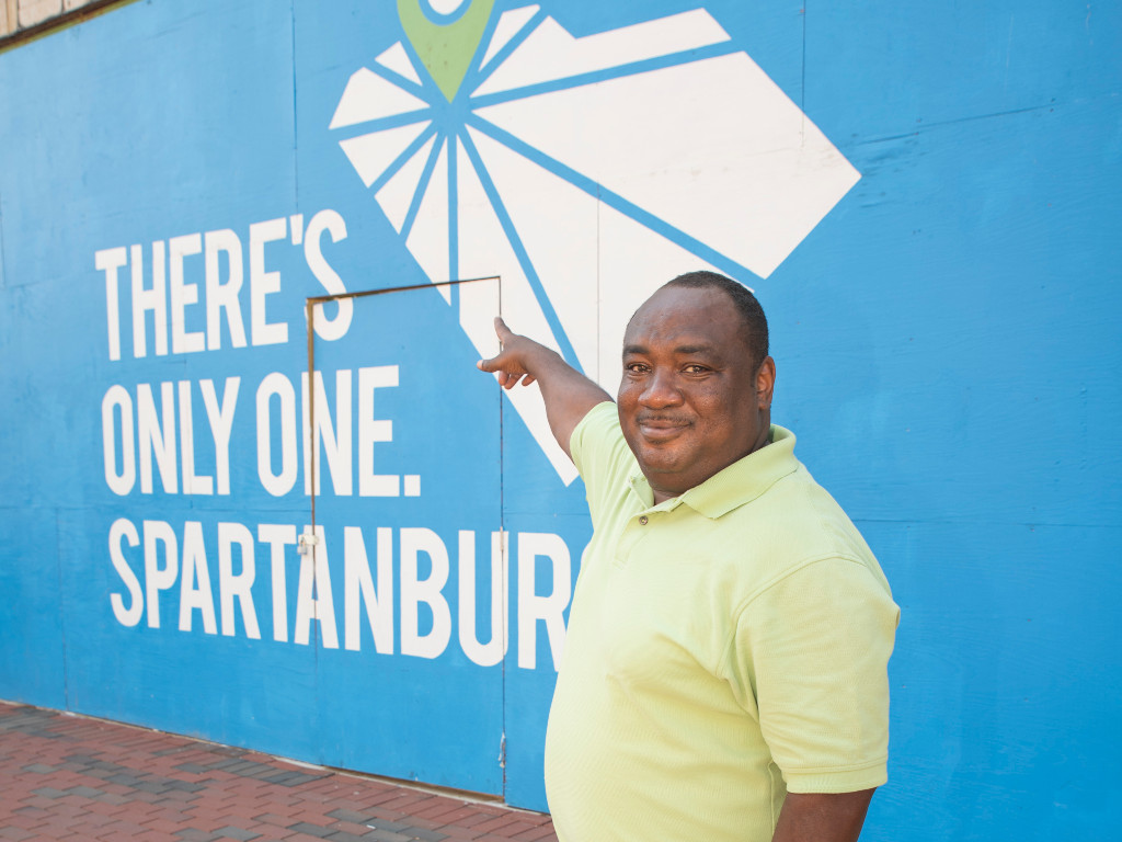 Photo of Mike Fowler in front of One Spartanburg painting